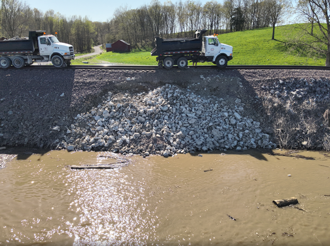 Riprap is placed to repair and protect a damaged embankment on the River Subdivision.
