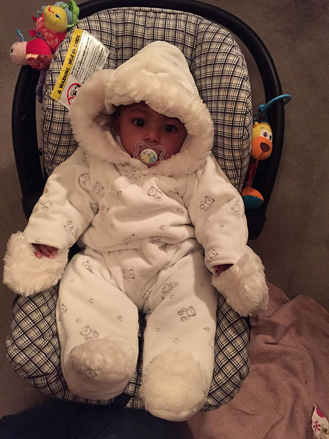 Daecian as a baby in his car seat 