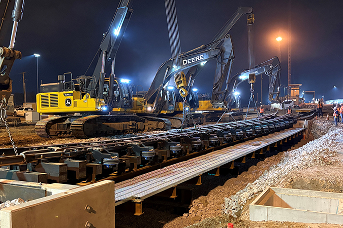 Work continued around the clock. During the night, crews set the Group 2 retarder in place on new bridge foundation.